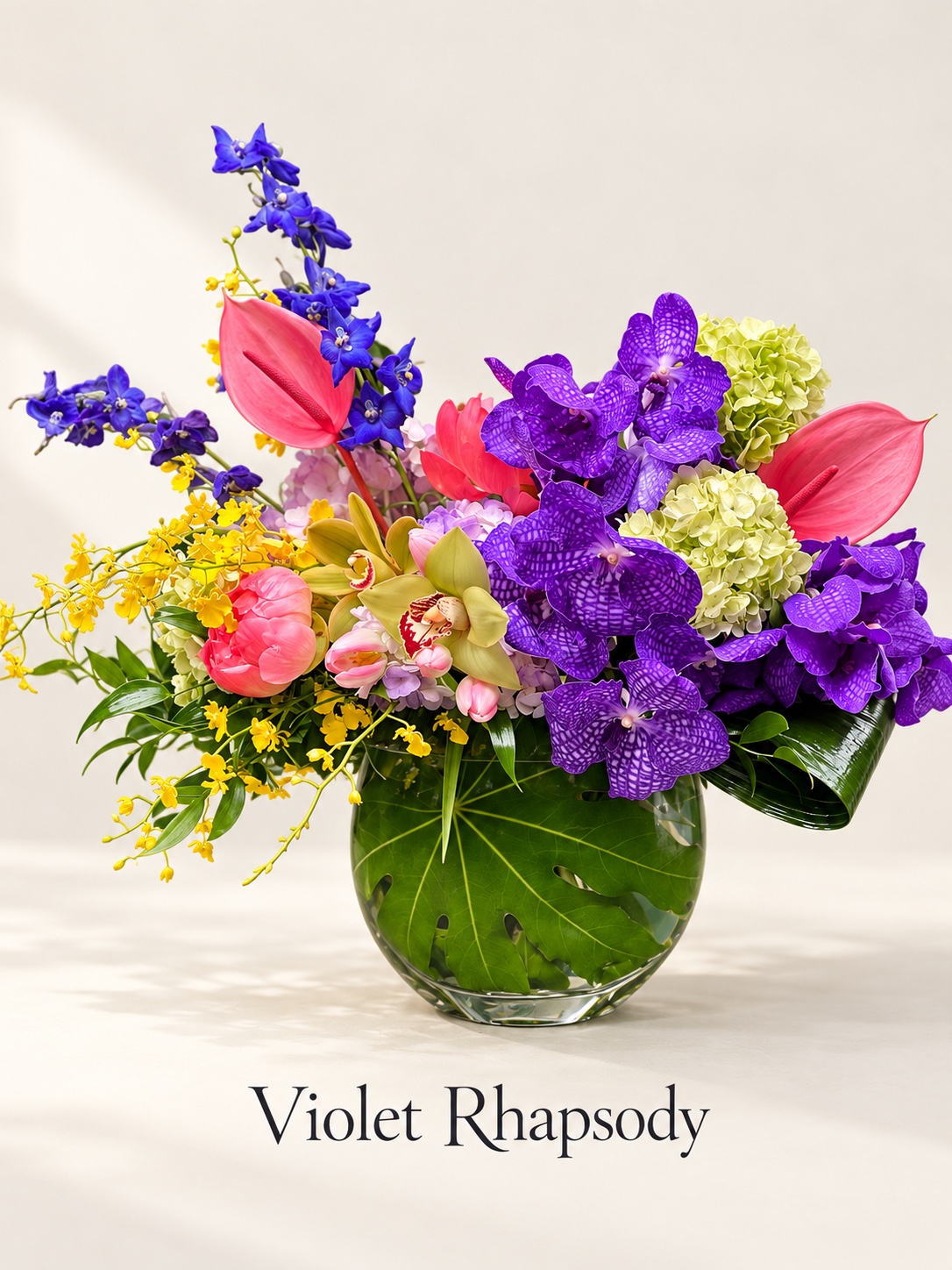 Violet Rhapsody purple orchid and tropical floral arrangement